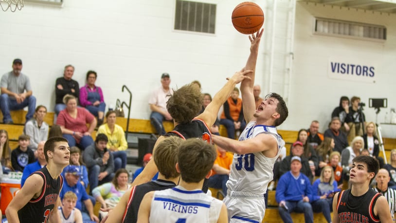 Miami East junior Jacob Roeth is fouled during Friday night's home victory over Versailles. Roeth scored his 1,000th point. CONTRIBUTED/Jeff Gilbert