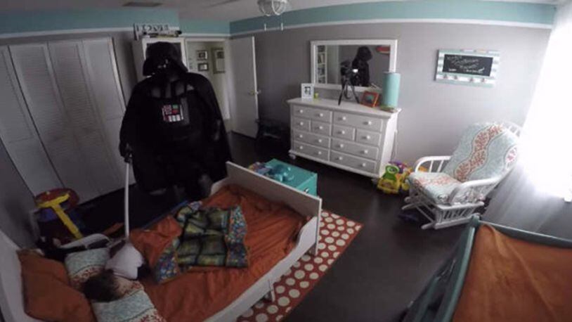 Rob Lopez wakes up son while dressed as Darth Vader. Photo via Rob Lopez/YouTube.