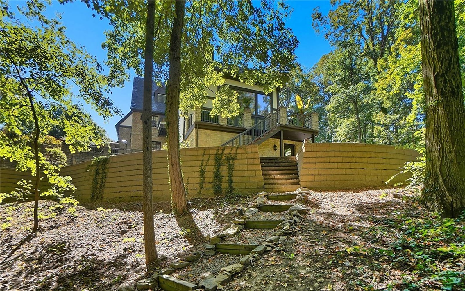 At the rear of the home are paths leading down to the woods. The lot is heavily wooded. CONTRIBUTED