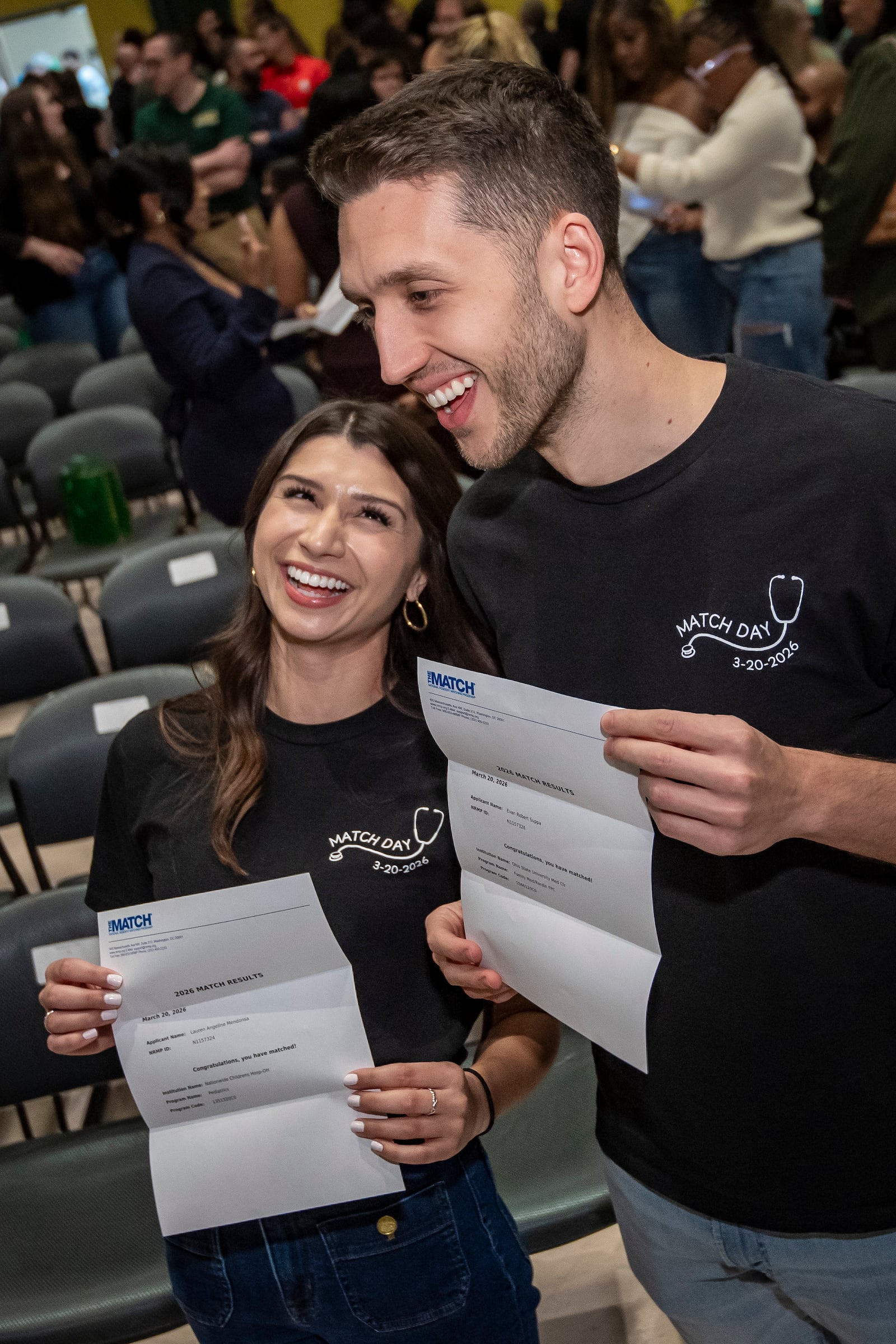 Medical students Lauren Mendonsa, left, and Evan Suppa show off their residency placements during the Match Day event at Wright State University Boonshoft School of Medicine on March 20, 2026. COURTESY OF WRIGHT STATE UNIVERSITY