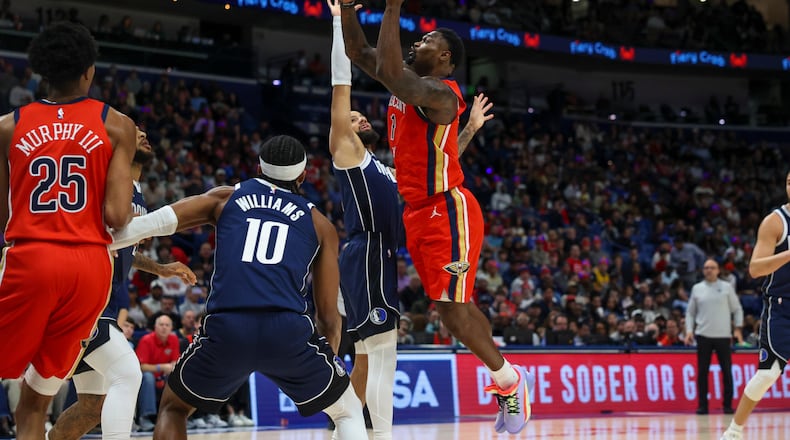New Orleans Pelicans forward Zion Williamson (1) shoots a layup against Dallas Mavericks forward Daniel Gafford, left, in the first half of an NBA basketball game Monday, Dec. 22, 2025, in New Orleans. (AP Photo/Peter Forest)