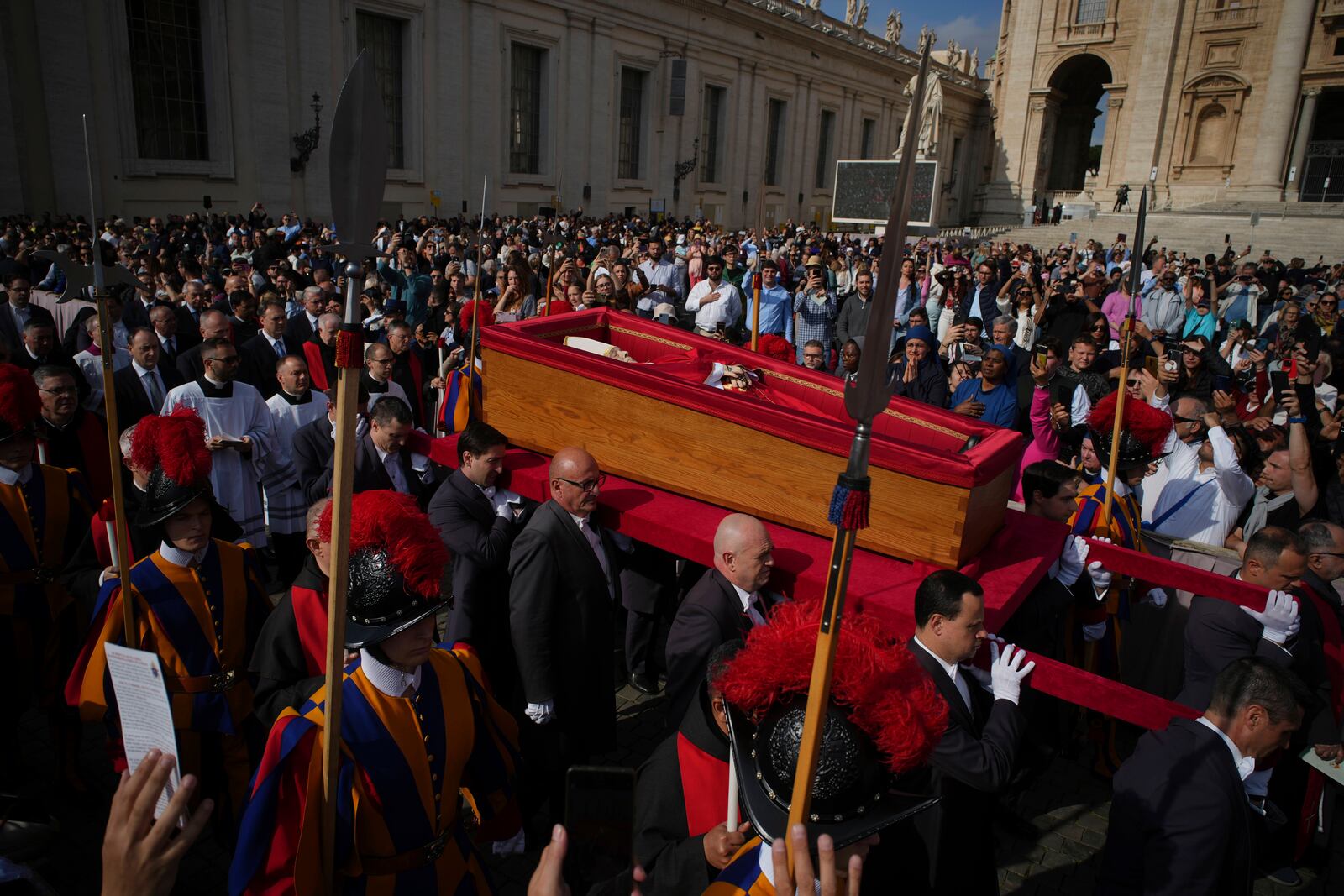 The body of Pope Francis is carried into St. Peter's Basilica at the Vatican, Wednesday, April 23, 2025, where he will lie in state for three days. (AP Photo/Emilio Morenatti)