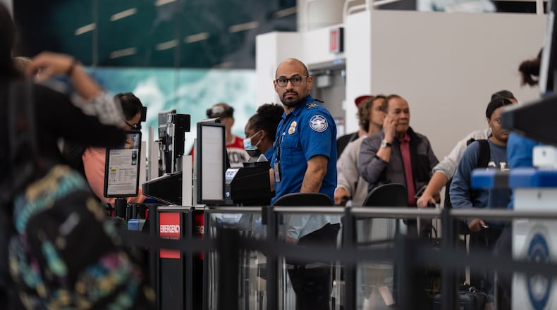 A TSA agent works at Los Angeles International Airport in Los Angeles, Friday, March 27, 2026. (AP Photo/Jae C. Hong)