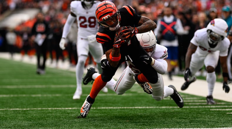 Bengals receiver Ja'Marr Chase reaches out to score a touchdown in the first quarter of their game against the Arizona Cardinals on Sunday, Dec. 28 at Paycor Stadium. JEREMY MILLER / CONTRIBUTED PHOTO