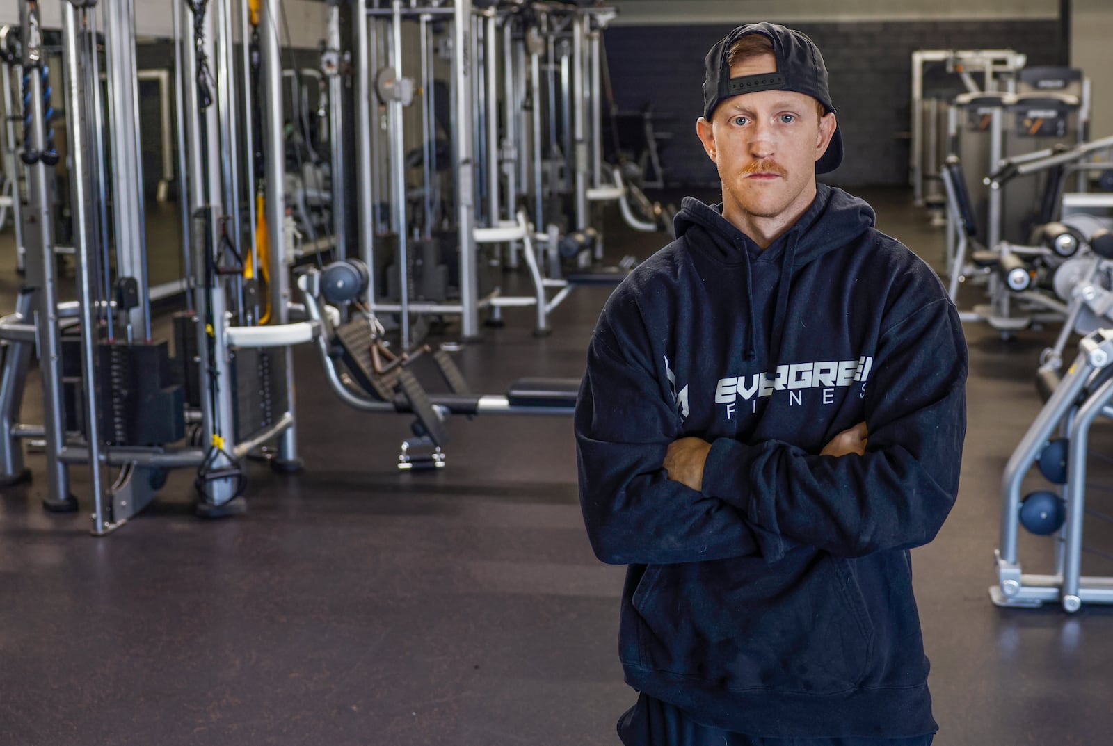Ryan Kibler, personal trainer/online coach at Evergreen Fitness, stands by machinery in his gym on Thursday, Jan. 22, 2026, in Springfield. JOSEPH COOKE/STAFF