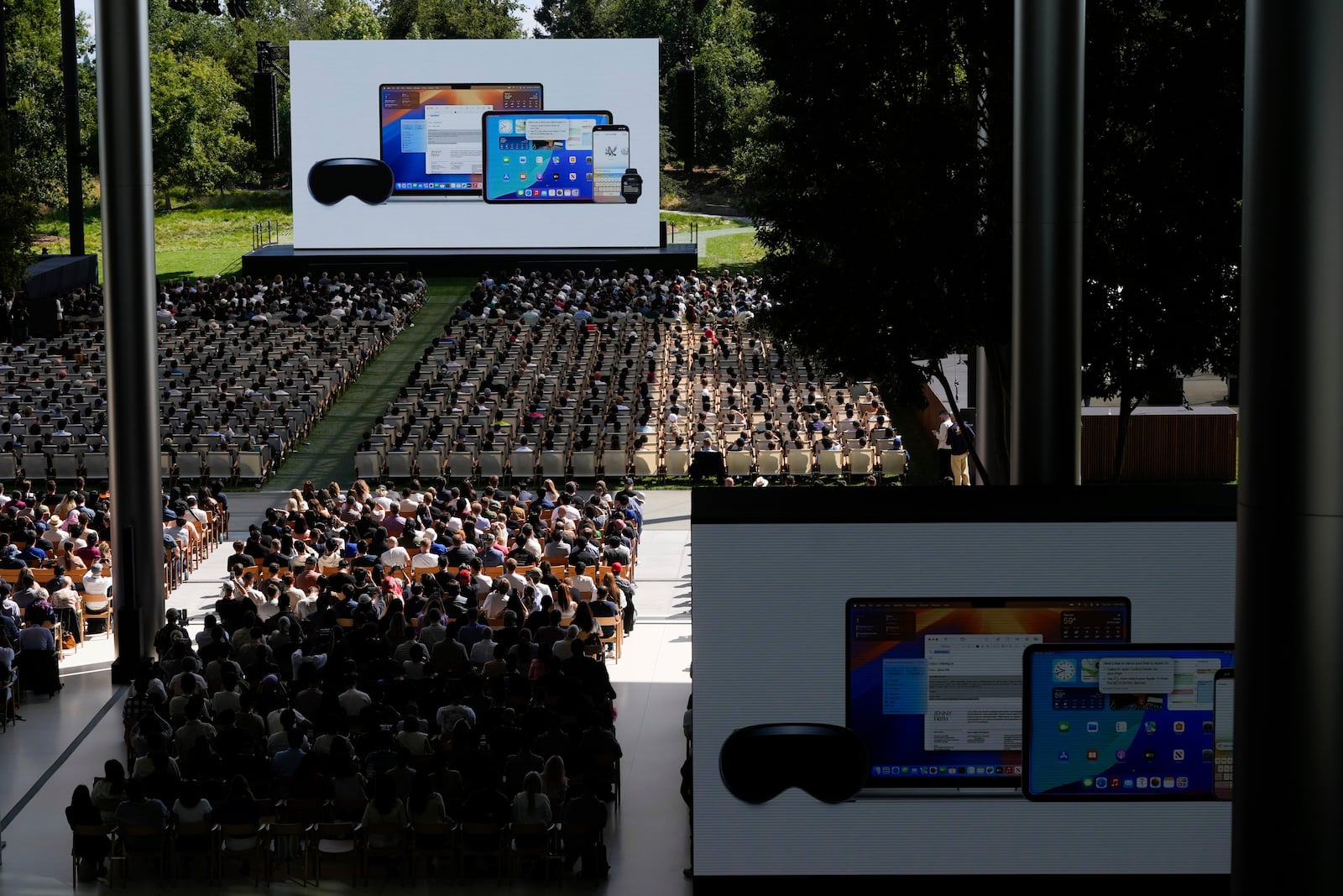 Attendees watch a presentation during an event on the Apple campus in Cupertino, Calif., Monday, June 9, 2025. (AP Photo/Jeff Chiu)