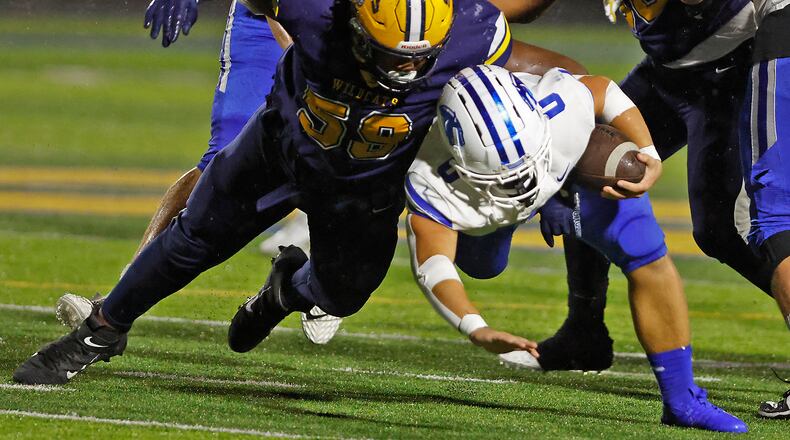 Springboro's Mattias Brunicardi is tackled by Springfield's Royce Rogers during Friday night's game in Springfield. BILL LACKEY/STAFF