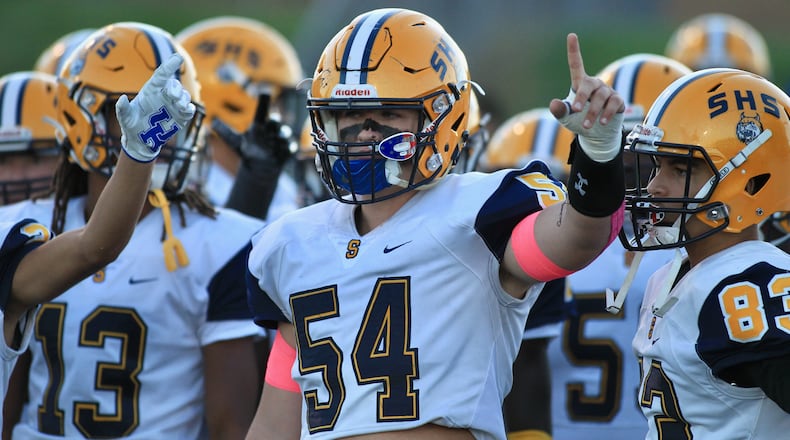 Springfield players, including Kraeton Muenchau, prepare to take the field against Springboro on Friday, Oct. 1, 2021, at CareFlight Field in Springboro. David Jablonski/Staff