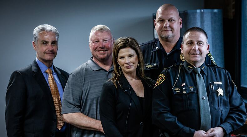 From left, FBI Special Agent Rick Ruggieri, Troy and Robyn Bodine, Brookville Police Chief Doug Jerome, and Montgomery County Sheriff Rob Streck. Law enforcement officials helped rescue Robyn and her friend, Tracie Shoe, when the pair became stranded in New Mexico's Gila National Forest. JIM NOELKER/STAFF