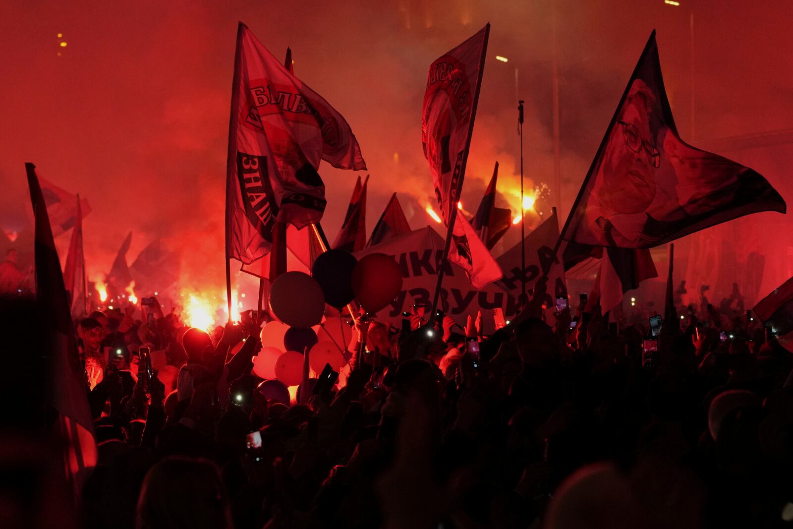 Supporters of Serbia's President Aleksandar Vucic gather during a rally, apparently designed to counter student-led gatherings, in Belgrade, Serbia, Saturday, April 12, 2025. (AP Photo/Darko Vojinovic)