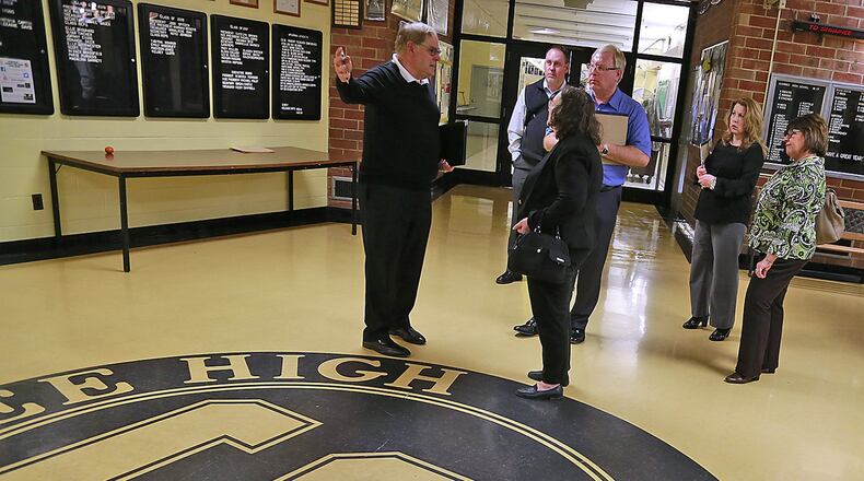 Greg Morris, left, the superintendent of Shawnee School District, shows school board members where the seventh and eighth grades will be located in Shawnee High School. Bill Lackey/Staff
