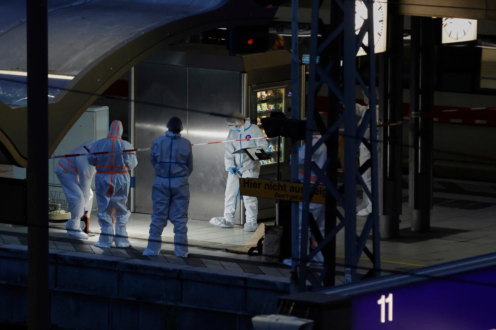Investigators work at Hamburg, Germany's Central Station on Friday, May 23, 2025, after several people were injured in a knife attack. (Georg Wendt/dpa via AP)