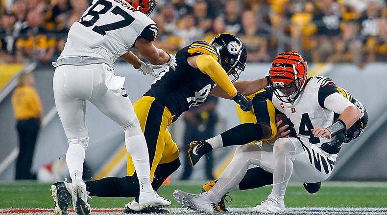PITTSBURGH, PENNSYLVANIA - SEPTEMBER 30: Quarterback Andy Dalton #14 of the Cincinnati Bengals is tackled by the defense of the Pittsburgh Steelers during the game at Heinz Field on September 30, 2019 in Pittsburgh, Pennsylvania. (Photo by Justin K. Aller/Getty Images)