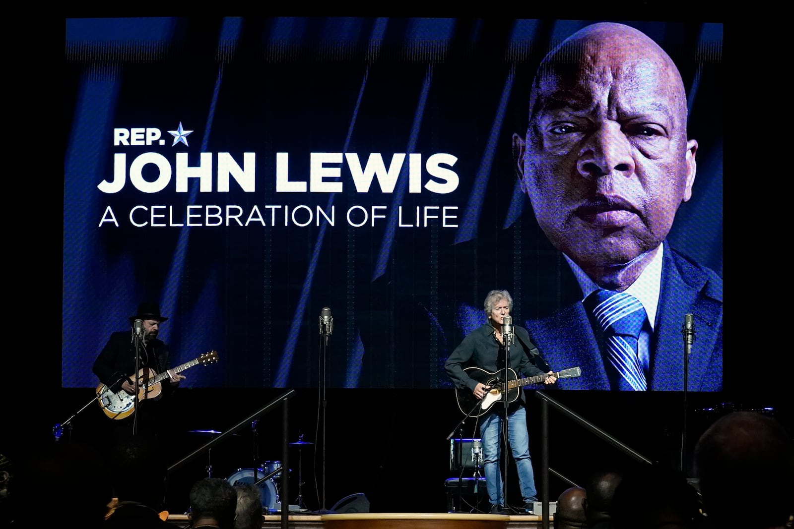 FILE - Rodney Crowell, right, performs in the Ryman Auditorium during a celebration of life marking the one-year anniversary of U.S. Rep. John Lewis's death, July 17, 2021, in Nashville, Tenn. (AP Photo/Mark Humphrey, file)