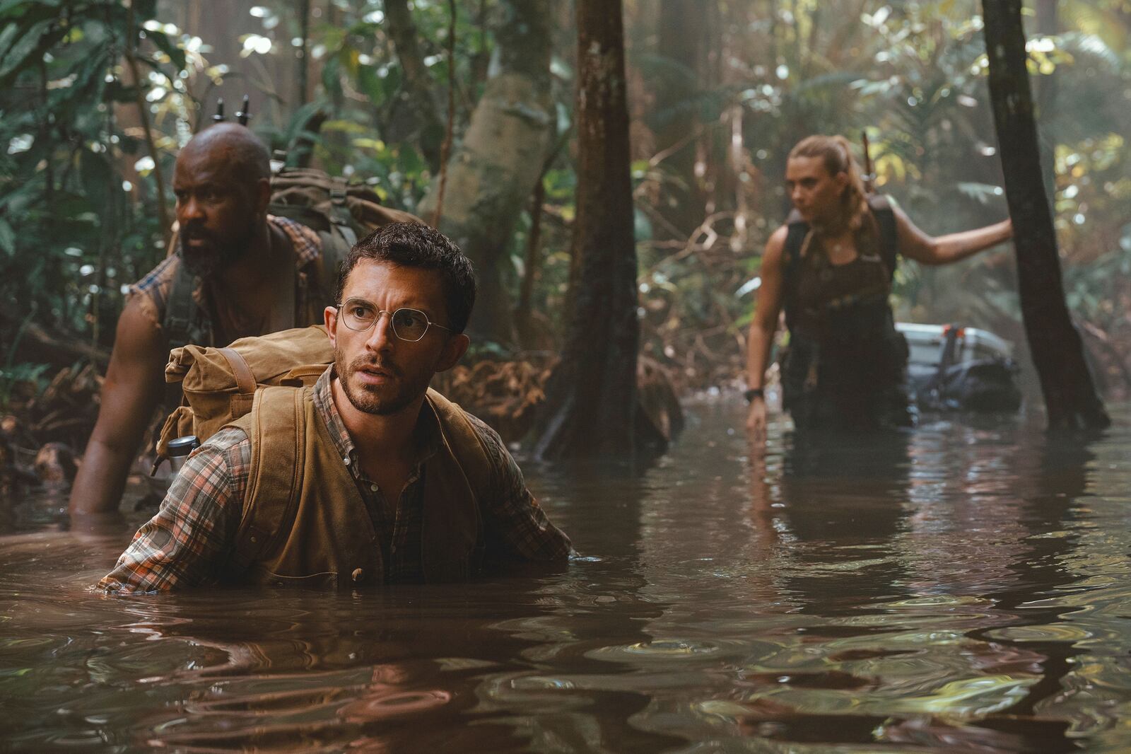 This image released by Universal Pictures and Amblin Entertainment shows, from left, Bechir Sylvain, Jonathan Bailey, and Scarlett Johansson in a scene from " Jurassic World Rebirth." (Jasin Boland/Universal Pictures and Amblin Entertainment via AP)