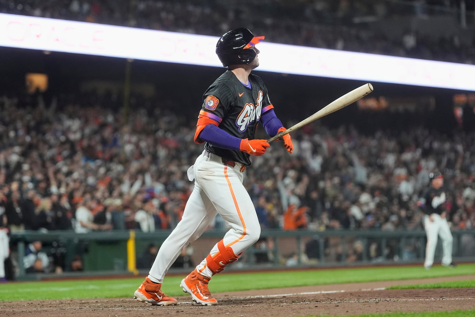 San Francisco Giants' Patrick Bailey watches the flight of his ball before running on his three-run inside the park home run during the ninth inning of a baseball game to defeat the Philadelphia Phillies in San Francisco, Tuesday, July 8, 2025. (AP Photo/Jeff Chiu)