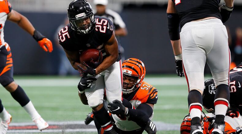 ATLANTA, GA - SEPTEMBER 30: Ito Smith #25 of the Atlanta Falcons is tackled by Preston Brown #52 of the Cincinnati Bengals during the third quarter at Mercedes-Benz Stadium on September 30, 2018 in Atlanta, Georgia. (Photo by Kevin C. Cox/Getty Images)