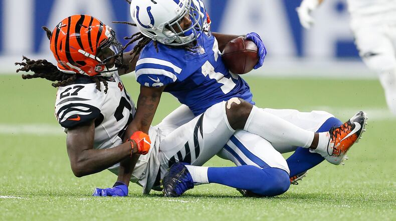 Cincinnati Bengals defensive back Dre Kirkpatrick (27) hauls down Indianapolis Colts wide receiver T.Y. Hilton (13) in the second half on Sunday, Sept. 9, 2018 at Lucas Oil Stadium in Indianapolis, Ind. The Indianapolis Colts lost 34-23 to the Cincinnati Bengals. (Sam Riche/TNS)