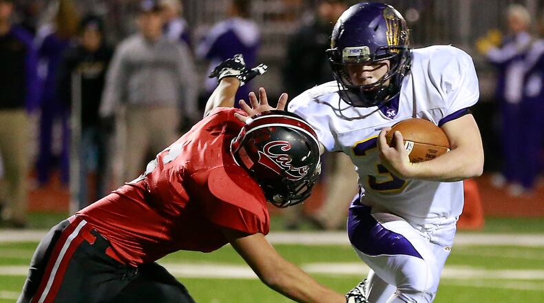 Mechanicsburg’s Dustin Knapp tries to avoid a tackle by Jefferson’s Brenen Auer last season. Bill Lackey/Staff