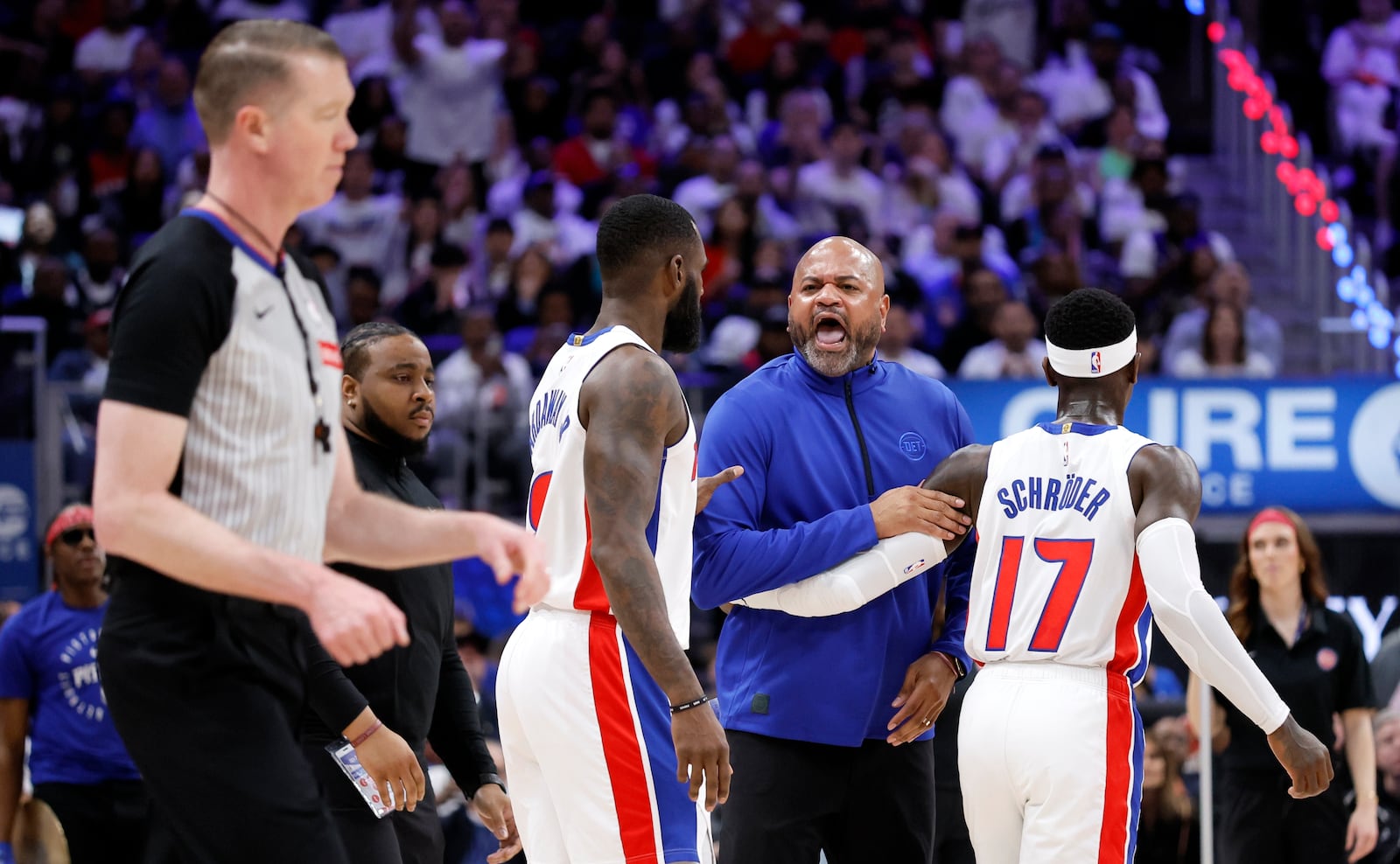 Detroit Pistons head coach J.B. Bickerstaff, second from front right, crosses the court to yell at referee Ed Malloy, left, while being held back by Pistons forward Tim Hardaway Jr., third from front right, and guard Dennis Schroder (17) during the first half of Game 6 of an NBA basketball first-round playoff series against the New York Knicks, Thursday, May 1, 2025, in Detroit. (AP Photo/Duane Burleson)