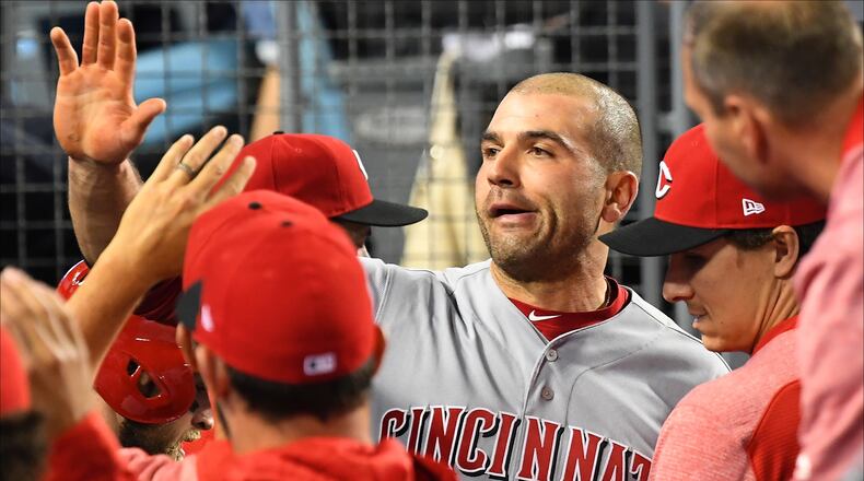 LOS ANGELES, CA - MAY 10:  Joey Votto #19 of the Cincinnati Reds is greeted in the dugout after scoring a run in the fourth inning of the game against the Los Angeles Dodgers at Dodger Stadium on May 10, 2018 in Los Angeles, California.  (Photo by Jayne Kamin-Oncea/Getty Images)