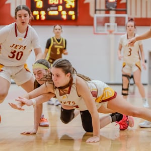 Northeastern's Taylor Krauss and Kenton Ridge's Addison Jenkins dive for a loose ball during their game at the Clark County Basketball Showcase on Tuesday, Dec. 30 at Pam Evans Smith Arena in Springfield. MICHAEL COOPER / CONTRIBUTED PHOTO