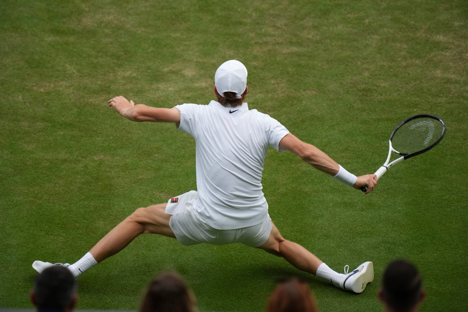 Jannik Sinner of Italy slips and almost falls as he plays Aleksandar Vukic of Australia during their second round men's singles match at the Wimbledon Tennis Championships in London, Thursday, July 3, 2025. (AP Photo/Alastair Grant)