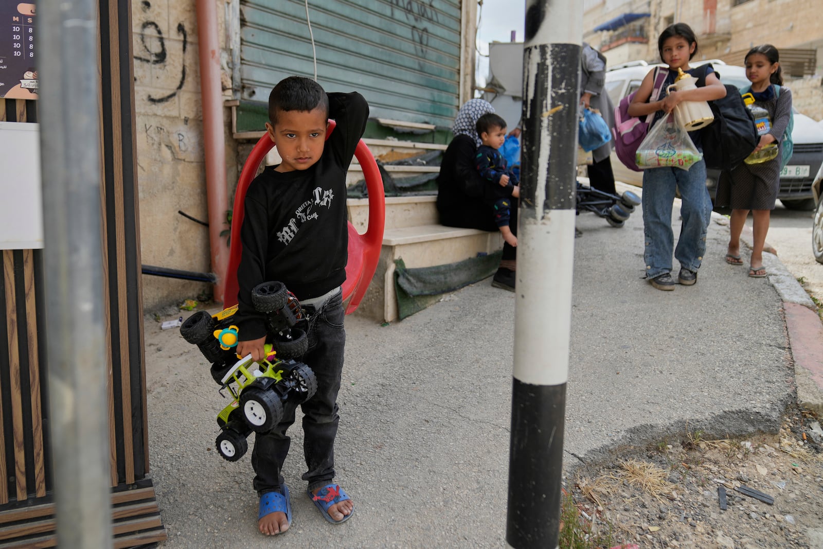Residents of the now evacuated refugee camp of Tulkarem return to collect belongings before the destruction of their homes as Israeli forces prepare to carry out the demolition of 116 homes across the two refugee camps of the Israeli occupied West Bank city of Tulkarem, Friday, May 2, 2025. (AP Photo/Nasser Nasser)