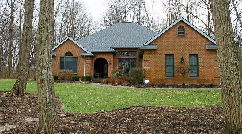 The 4-bedroom home offers four bedrooms and approximately 3,060 square feet of living space. Exterior features include an attached, 3-car garage. CONTRIBUTED PHOTOS BY VICKIE KAPNAS