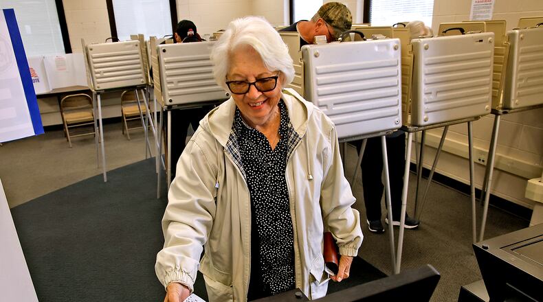 Jennie Zimmer slides her ballot into the voting machine after voting early at the Clark County Board of Elections Tuesday, Oct. 17, 2023. BILL LACKEY/STAFF