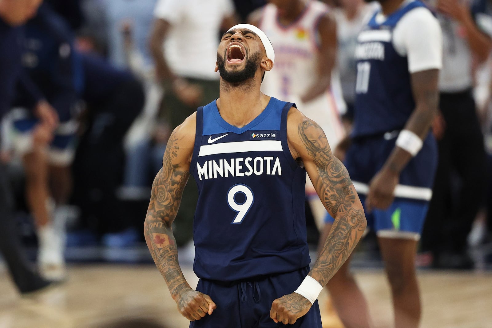 Minnesota Timberwolves guard Nickeil Alexander-Walker (9) celebrates after a 3-point basket by Donte DiVincenzo during the second half of Game 4 of the Western Conference finals of the NBA basketball playoffs against the Oklahoma City Thunder Monday, May 26, 2025, in Minneapolis. (AP Photo/Matt Krohn)