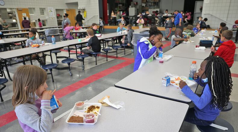 Third grade students at Lincoln Elemetary social distance as they eat their lunches Wednesday. BILL LACKEY/STAFF