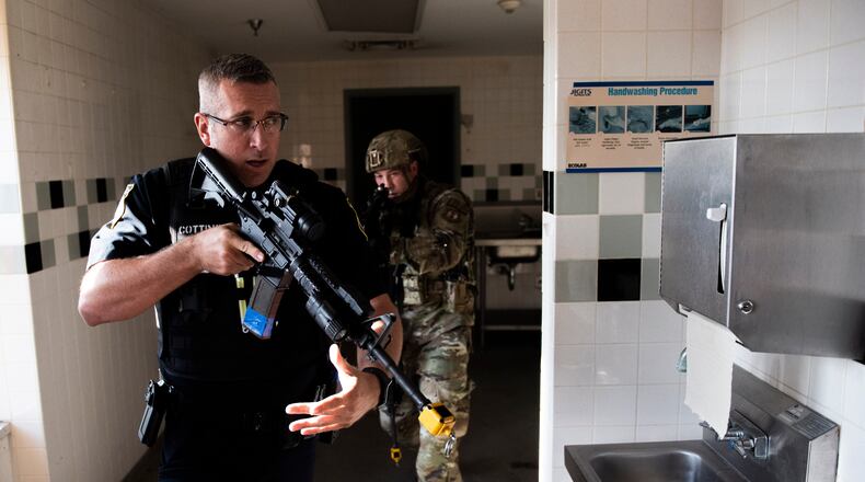 Members of the 88th Security Forces Squadron work to clear a building during an active shooter exercise, Aug. 18 at Wright-Patterson Air Force Base. (U.S. Air Force photo by Wesley Farnsworth)