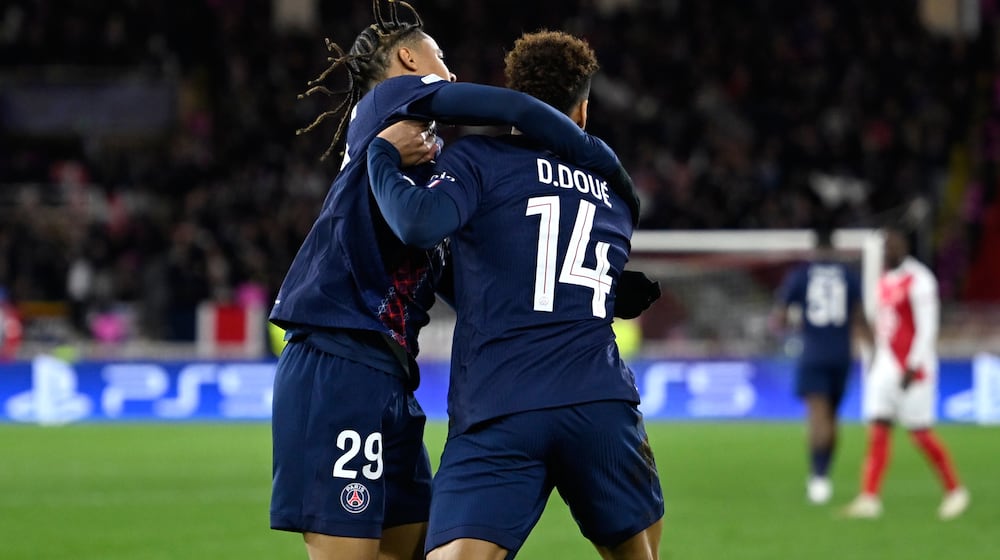 PSG's Desire Doue, right, celebrates with PSG's Bradley Barcola after scoring his side's opening goal during the first-leg of the Champions League playoff soccer match between Monaco and Paris Saint-Germain in Monaco, Tuesday, Feb. 17, 2026. (AP Photo/Philippe Magoni)