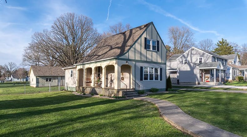 The front of the home features a covered front porch and long concrete walk. Contributed photos