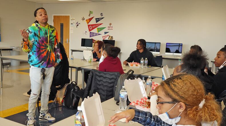 Kareem Crossley, the owner of Bubby's Chicken & Waffles, talks to a group of Springfield High School students about the rewards and struggles of starting your own business Thursday as they enjoy the chicken and waffle meals he brought for them. BILL LACKEY/STAFF