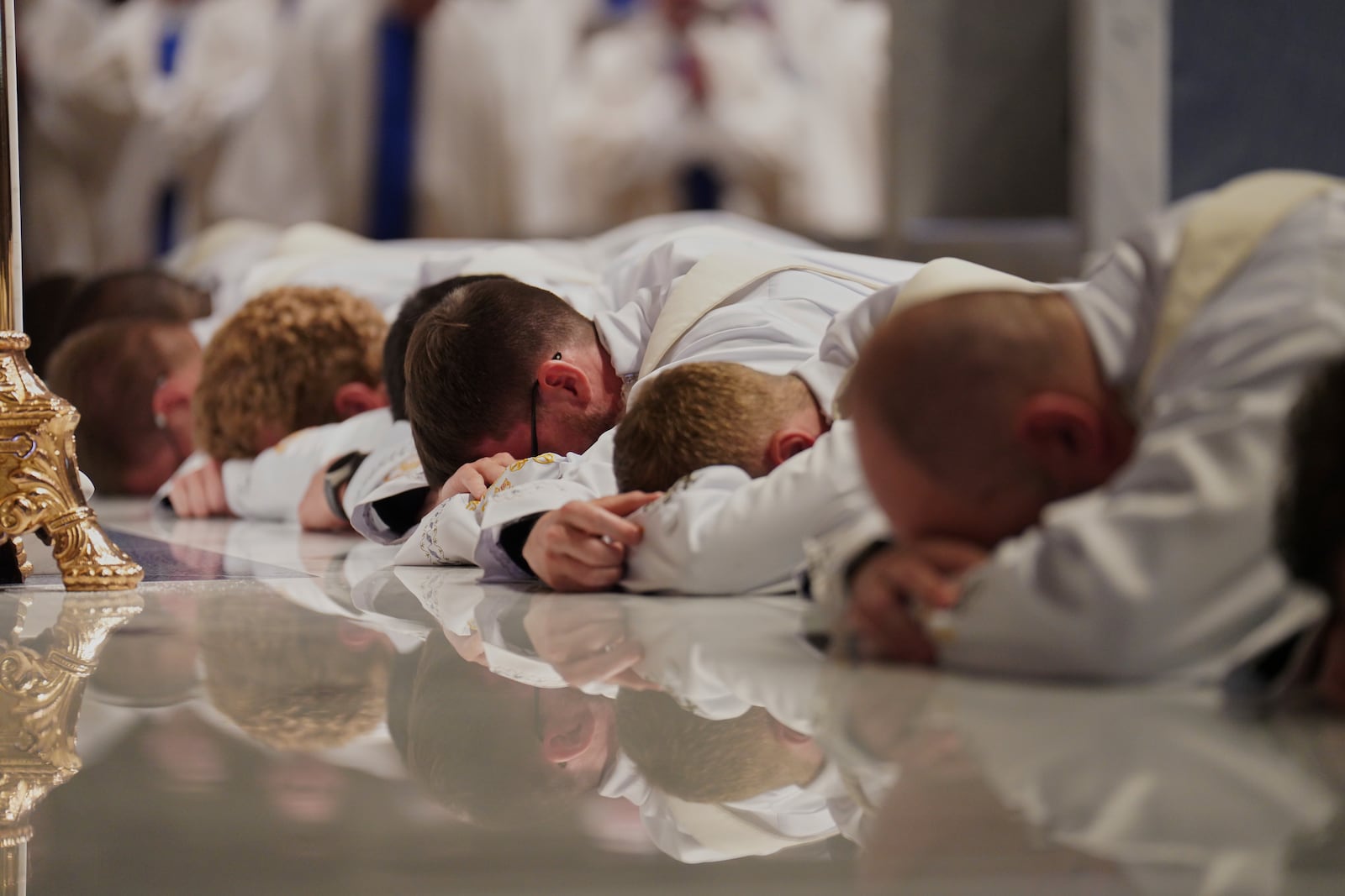Twelve deacons prostrate in front of the altar at the Cathedral of Saint Thomas More during their ordination Mass in Arlington, Va., on Saturday, June 7, 2025. (AP Photo/Jessie Wardarski)