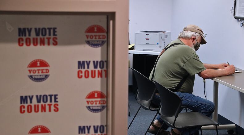 A voter casts his vote at the Champaign County Board of Election during the April election. BILL LACKEY/STAFF