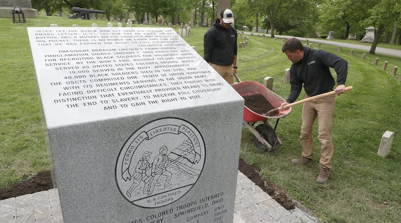 Mike Turner, right, and Nick McMaken, of Turner Landscaping, put the finishing touches on the walkway for the new monument honoring the United States Colored Troops who fought in the Civil War and are buried in Ferncliff Cemetery Wednesday. The new monument is located in the Civil War veteran’s section. Roughly 179,000 United States Colored Troops served in the Civil War and approximately 40,000 black soldiers died in the war. The monument was supposed to be dedicated on Veterans Day, however, since the Veterans Day activities were canceled, the dedication will be held at a later date. BILL LACKEY/STAFF
