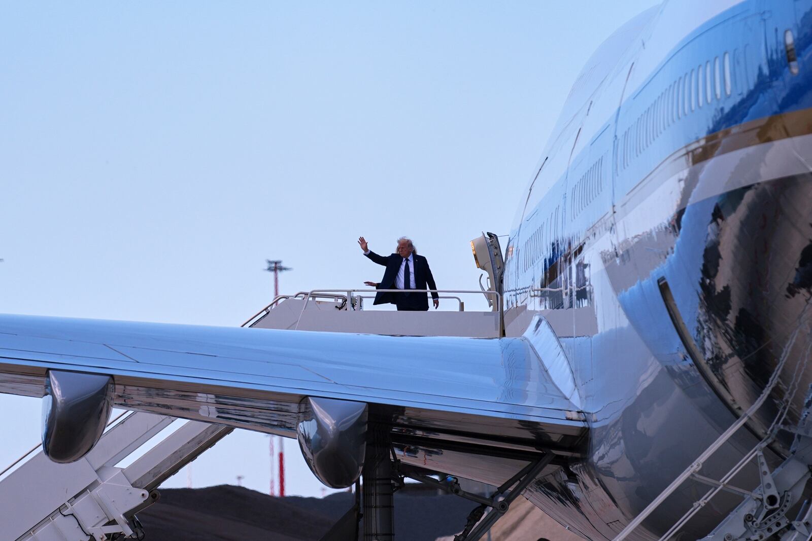 President Donald Trump and first lady Melania Trump wave before they board Air Force One at Leonardo da Vinci International Airport, Saturday, April 26, 2025, in Rome, after attending the funeral of Pope Francis at the Vatican. (AP Photo/Evan Vucci)