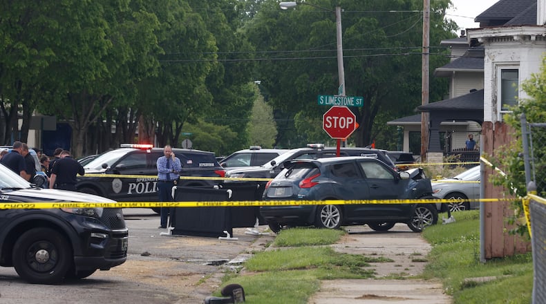 Authorities investigate a fatal shooting that resulted in a crash on South Limestone Street and East Euclid Avenue on Wednesday, May 14, 2025. JOSEPH COOKE/STAFF