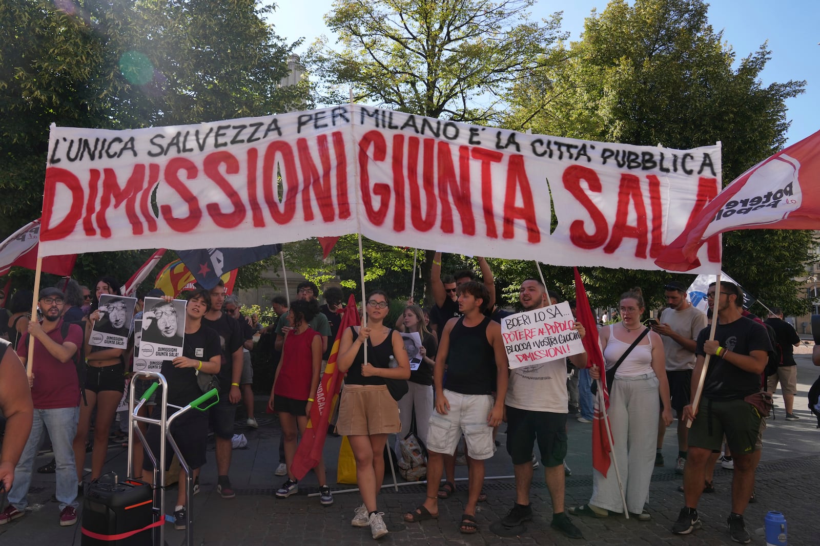 People ask for the resignation of Milan's Mayor Giuseppe Sala outside the City Council Monday, July 21, 2025, in Milan, northern Italy, as prosecutors are investigating more than 70 individuals, including Mayor Sala, over a sprawling corruption probe into the city's real estate industry. (AP Photo/Antonio Calanni)