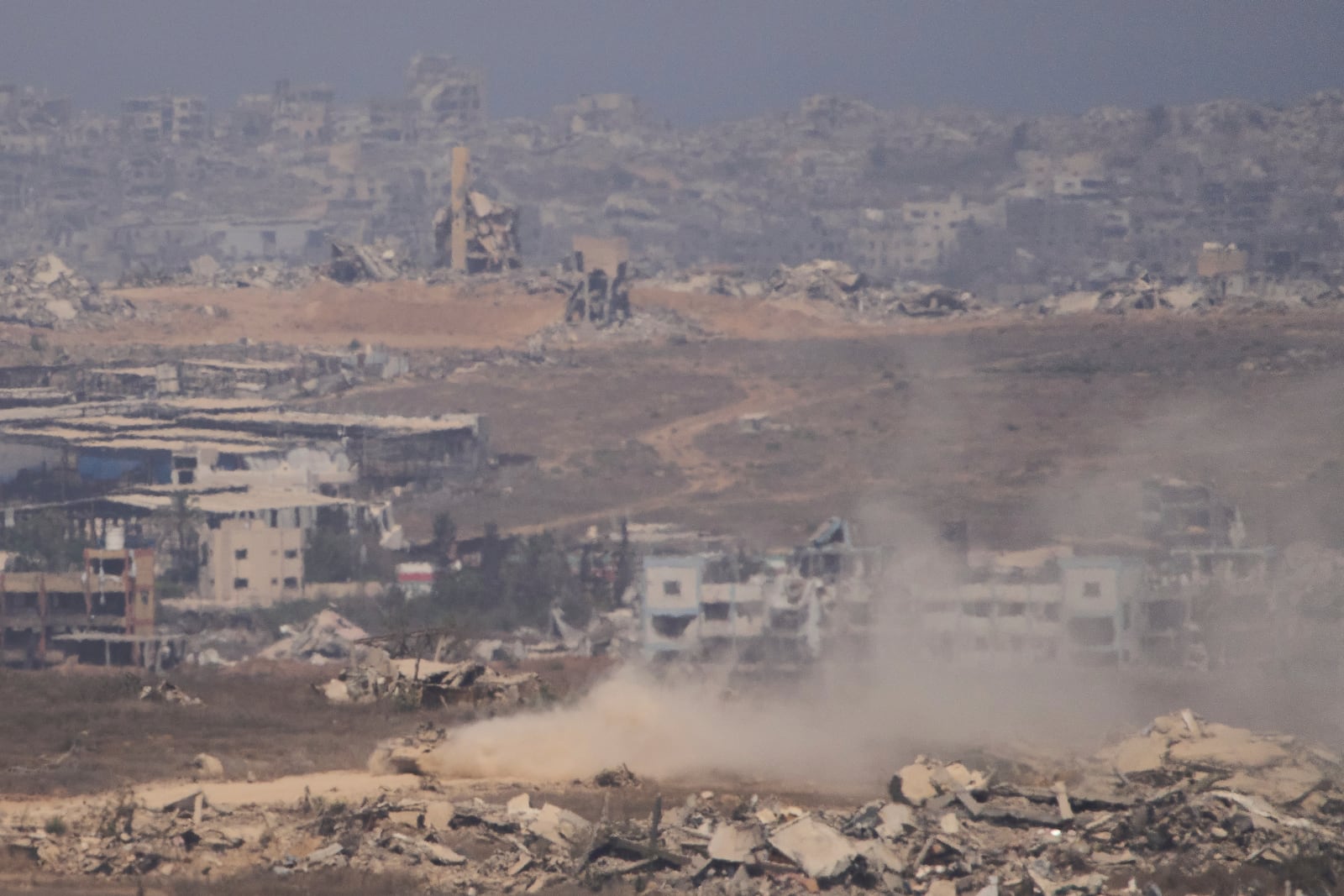 Israeli soldiers drive on their armored personnel carrier inside the northern Gaza Strip, as seen from southern Israel, Tuesday, July 29, 2025. (AP Photo/Ariel Schalit)