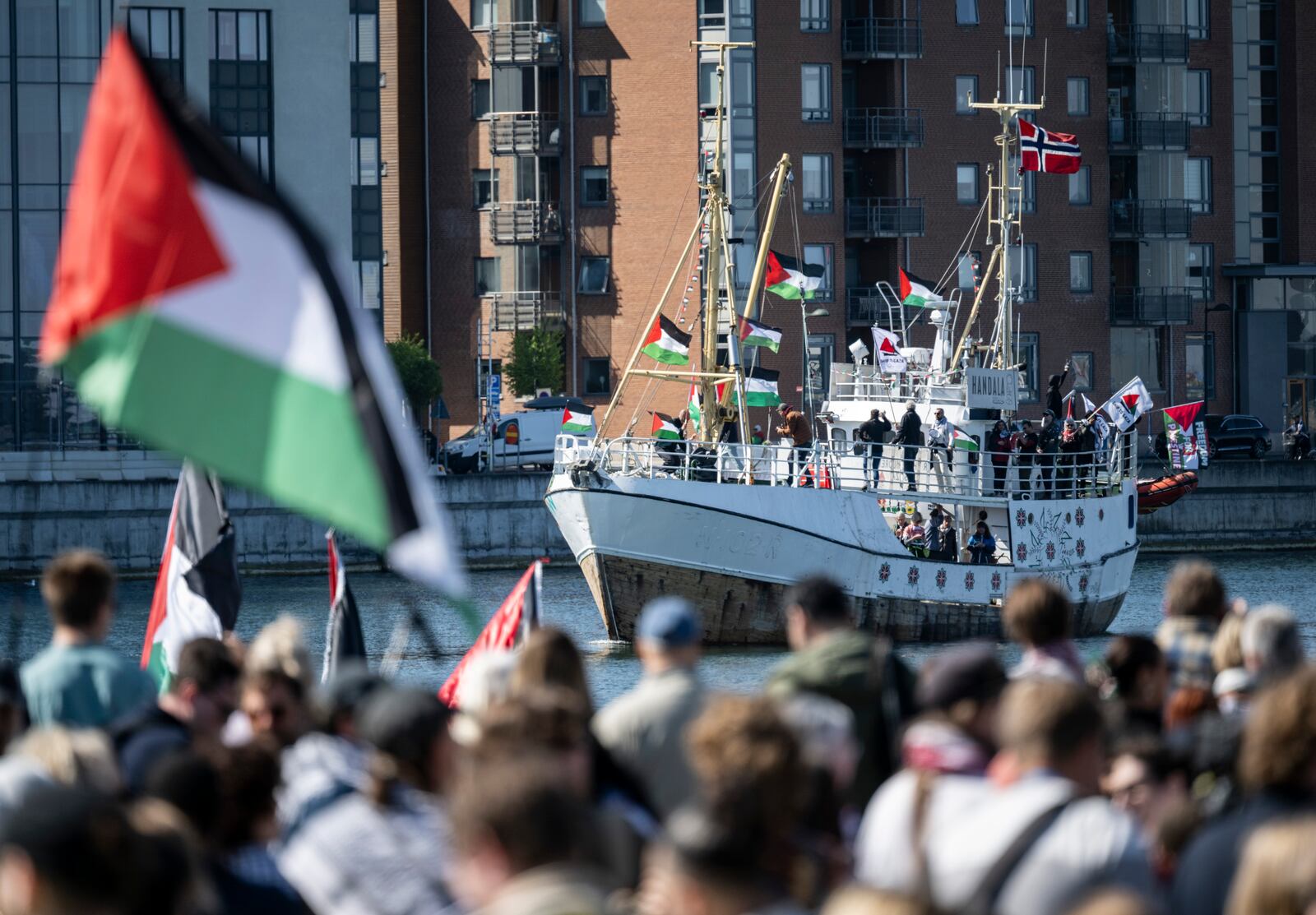 FILE - Demonstrators carrying Palestinian flags look on as the Ship to Gaza boat 'Handala' arrives at the port of Malmö, Sweden, Wednesday, May 8, 2024.(Johan Nilsson/TT News Agency via AP, File)