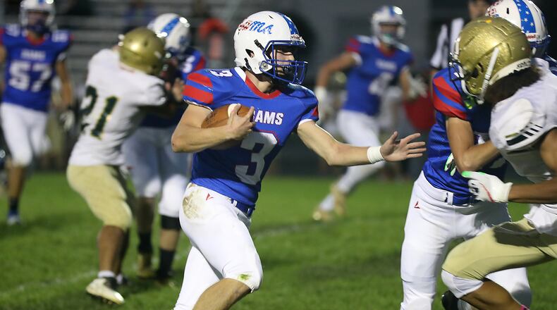 Cole Dehaven rushes for a touchdown against Catholic Central. BILL LACKEY/STAFF
