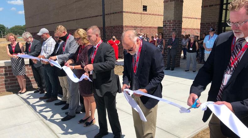 Greenon Local School Districts Board of Education is conducting interviews for a new treasurer. Here, board members and others cut the ribbon last month when they officially welcomed crowds to Greenon Schools' new K-12 campus. Photo by Brett Turner