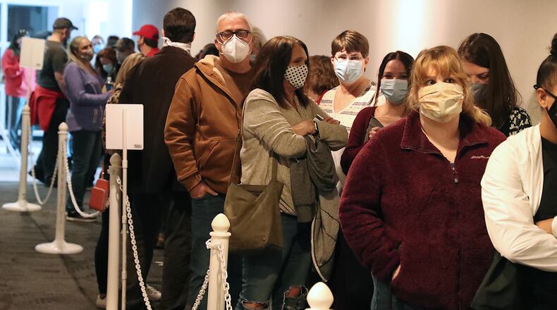 Champaign County Voters wait in line to vote early at the Board of Elections Monday. BILL LACKEY/STAFF