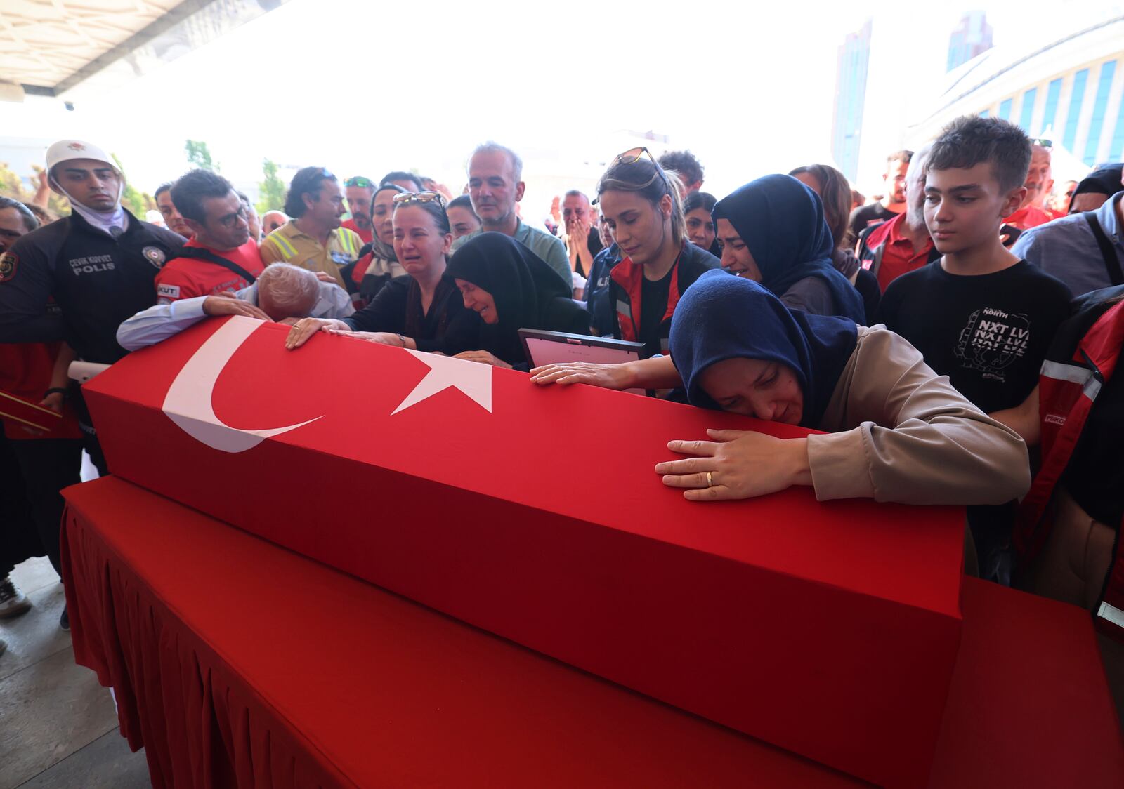 Relatives and friends mourn during the funeral of five rescue volunteers killed while battling a wildfire in northwestern Eskisehir province, in Ankara, Turkey, Thursday, July 24, 2025. (Yavuz Ozden/Dia Photo via AP)