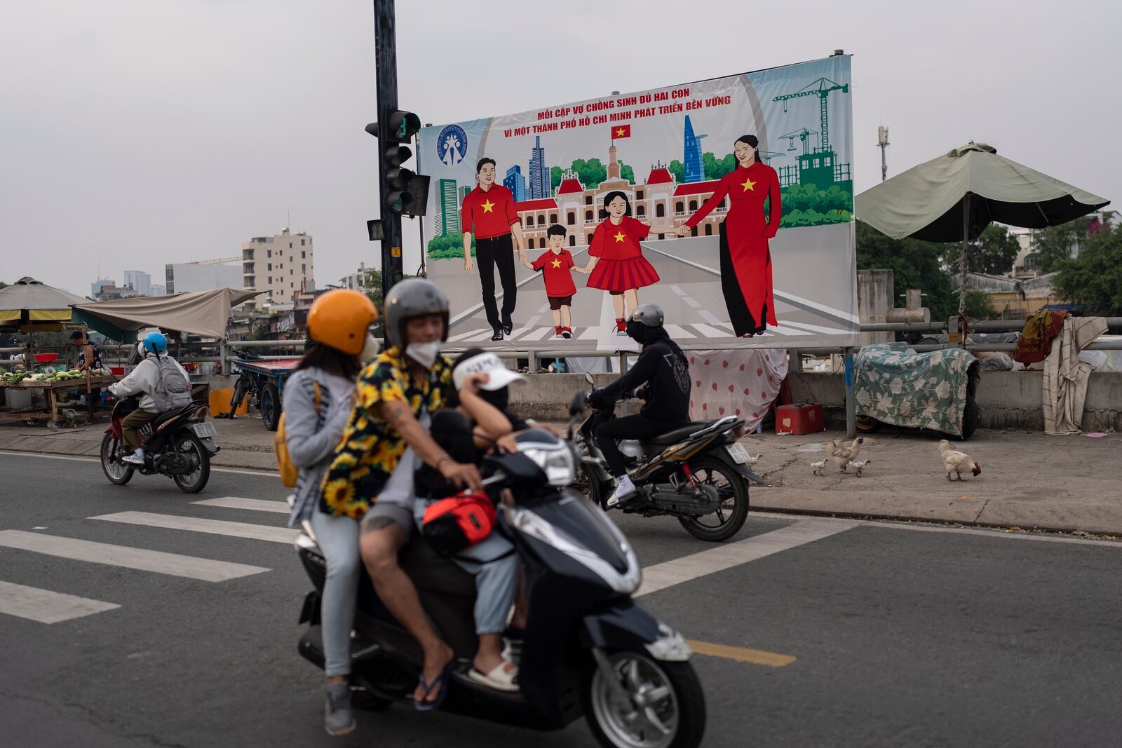 FILE -A billboard campaigning for each family to have two children in an effort to improve the birth rate stands along the street in Ho Chi Minh City, Vietnam, Jan. 14, 2024. (AP Photo/Jae C. Hong, File)