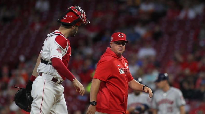 Reds pitch coach Derek Johnson, right, talks to catch Curt Casali after a mound visit during a game against the Astros on Monday, June 17, 2019, at Great American Ball Park in Cincinnati. David Jablonski/Staff